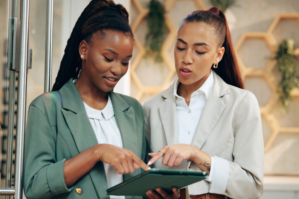 Collaboration,,Management,And,Tablet,With,Women,At,Hotel,Help,Desk